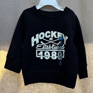 Place Black Sweatshirt with White Hockey Graphic